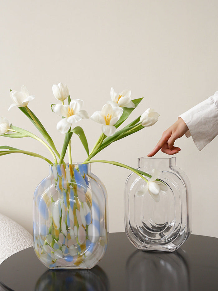 Clear glass vase shaped like a perfume bottle for decorative flower display