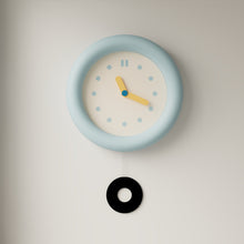 Baby blue silent wall clock with minimalist dial and pendulum