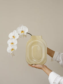 Clear glass vase shaped like a perfume bottle for decorative flower display