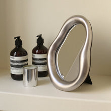 Beige irregular shaped vanity mirror for makeup and dressing table use