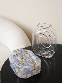 Clear glass vase shaped like a perfume bottle for decorative flower display