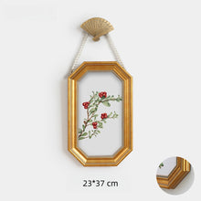 Set of eight vintage-inspired botanical, portrait, and landscape wall art pieces in assorted frames