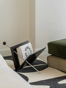 V-shaped cherry wood magazine rack with stainless steel detail