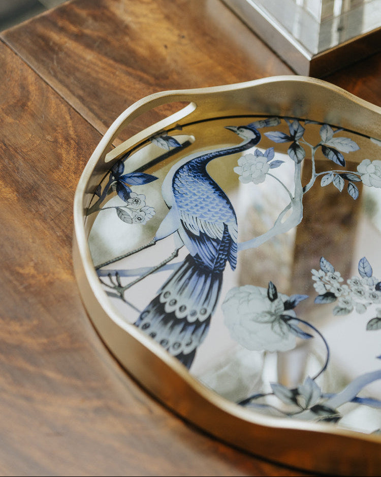 Peacock mirror decorative tray with floral motif and gold-toned wavy frame
