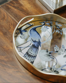 Peacock mirror decorative tray with floral motif and gold-toned wavy frame