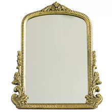 Gold carved vanity mirror with vintage French-inspired frame