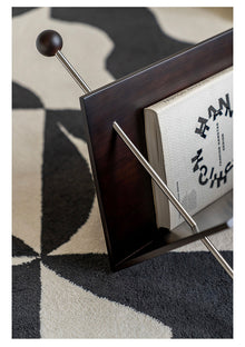 V-shaped cherry wood magazine rack with stainless steel detail
