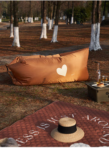 Inflatable outdoor lounger sofa for portable seating at the beach, campsite or garden