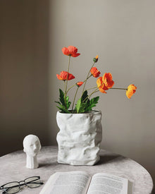Crumpled ceramic vase with folded paper inspired texture