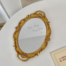 French vintage vanity mirror with ornate gold-tone frame