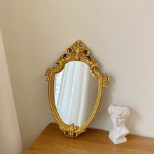 French vintage vanity mirror with ornate gold-tone frame