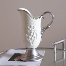 French embossed ceramic vase with floral relief detailing in silver