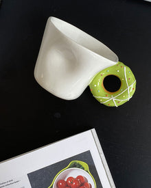 Ceramic mug with a playful donut-shaped handle