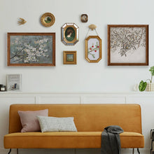 Set of eight vintage-inspired botanical, portrait, and landscape wall art pieces in assorted frames