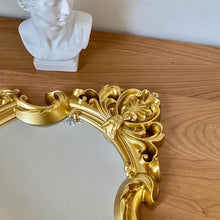 French vintage vanity mirror with ornate gold-tone frame