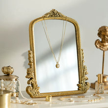 Gold carved vanity mirror with vintage French-inspired frame