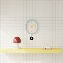 Oval light blue wall clock with pendulum for home decor