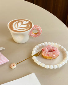 Ceramic mug with a playful donut-shaped handle