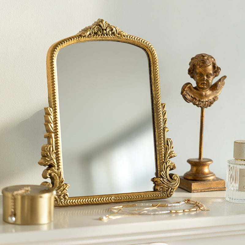 Gold carved vanity mirror with vintage French-inspired frame