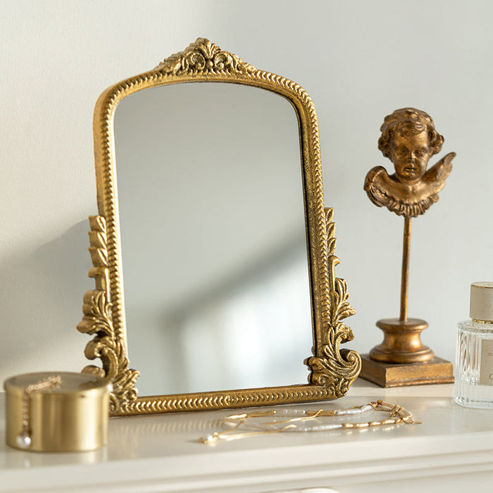 Gold carved vanity mirror with vintage French-inspired frame