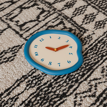 White asymmetrical drip wall clock with a playful melting-inspired shape