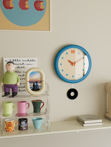 Vintage-style round blue wall clock with clean dial and pendulum