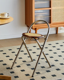 French-inspired walnut rattan folding stool with woven seat