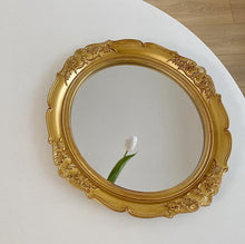 French vintage vanity mirror with ornate gold-tone frame