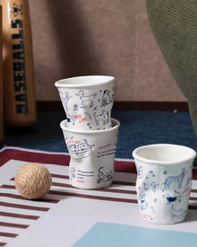 Set of four ceramic coffee cups with cat and dog illustrations