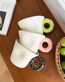 Ceramic mug with a playful donut-shaped handle