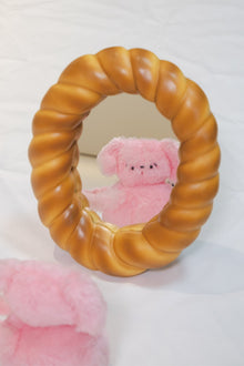Croissant-shaped decorative desk mirror with textured bread-inspired frame