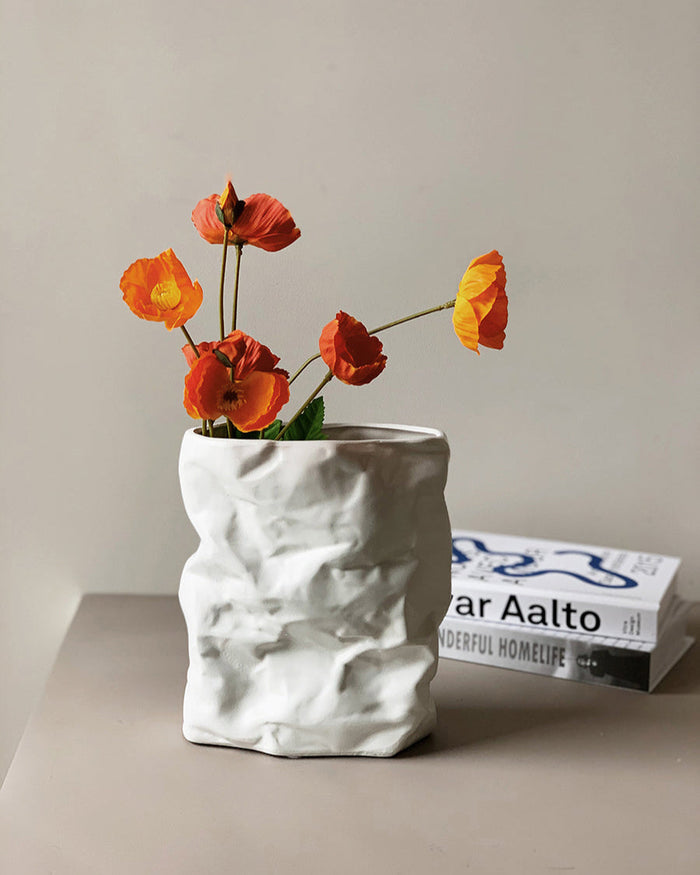 Crumpled ceramic vase with folded paper inspired texture