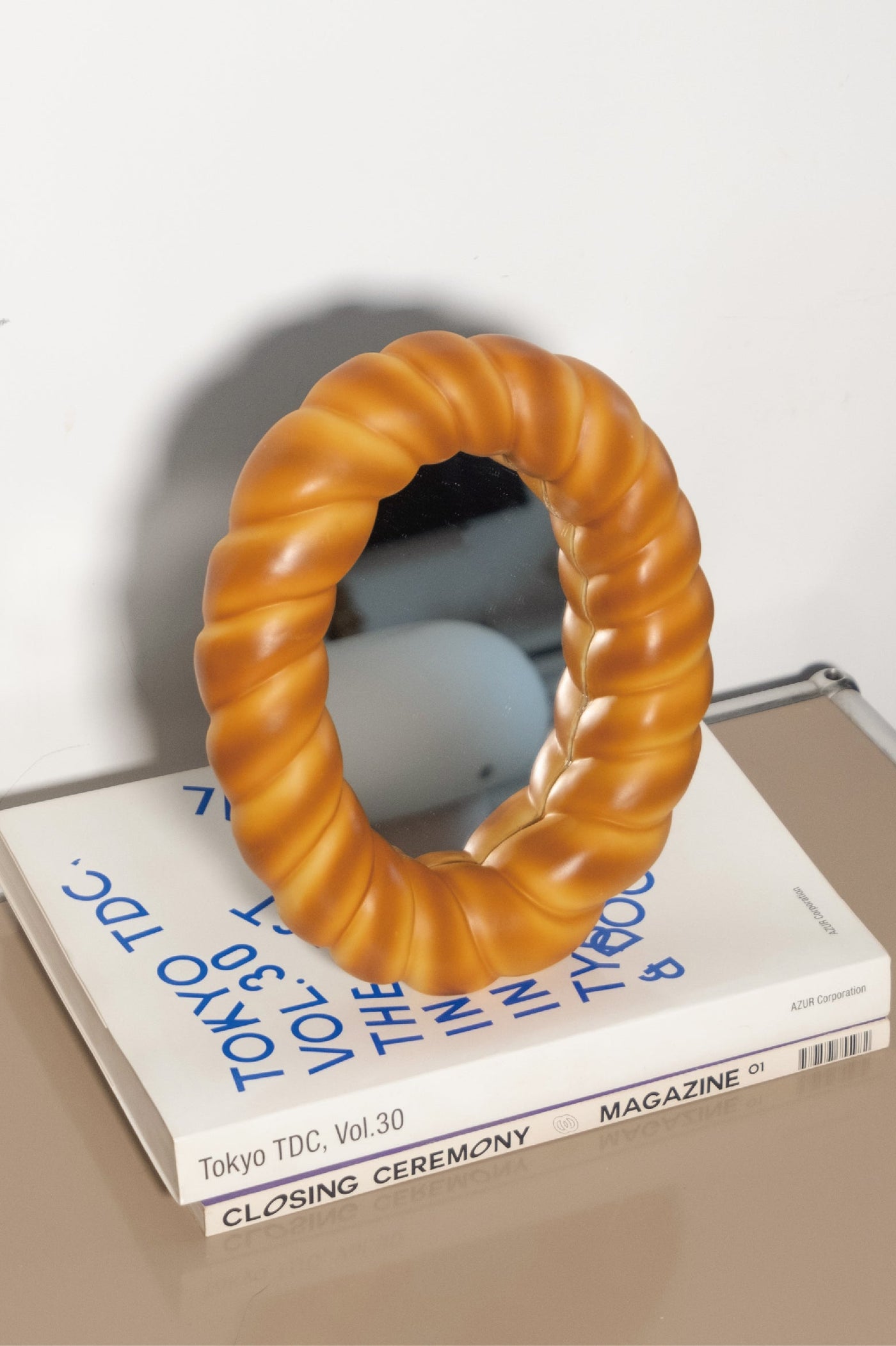 Croissant-shaped decorative desk mirror with textured bread-inspired frame