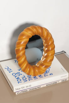 Croissant-shaped decorative desk mirror with textured bread-inspired frame