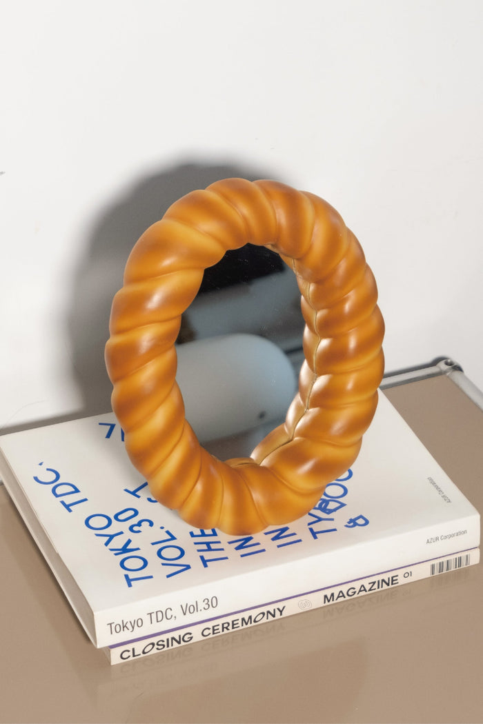 Croissant-shaped decorative desk mirror with textured bread-inspired frame