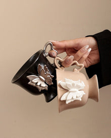 Beige ceramic mug with raised butterfly detail and butterfly-shaped handle