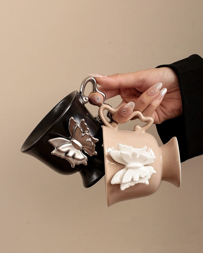 Beige ceramic mug with raised butterfly detail and butterfly-shaped handle