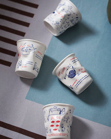 Set of four ceramic coffee cups with cat and dog illustrations