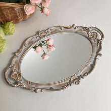 French vintage vanity mirror with ornate gold-tone frame