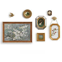 Set of eight vintage-inspired botanical, portrait, and landscape wall art pieces in assorted frames