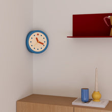 Blue corner wall clock with minimalist dot dial for a 90-degree wall edge