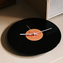 Black vinyl record-inspired clock with stand for wall or tabletop display