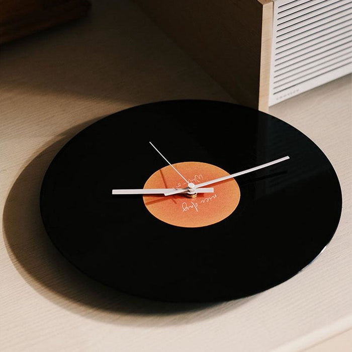 Black vinyl record-inspired clock with stand for wall or tabletop display