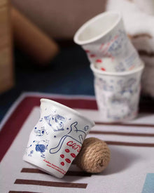 Set of four ceramic coffee cups with cat and dog illustrations