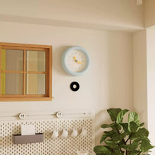 Baby blue silent wall clock with minimalist dial and pendulum