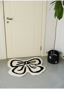 Black and white bowknot area rug with soft tufted texture