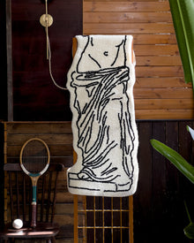 Black and white museum-inspired bedside rug with Leaning Tower of Pisa design
