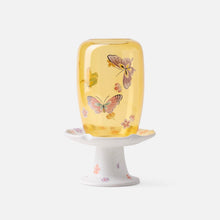Chinese-inspired glass and ceramic candle holder with decorative nature motifs
