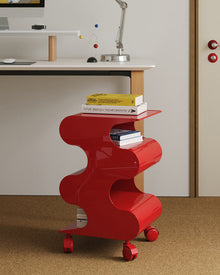 Modern green curved rolling side cart with open shelving and matching green wheels