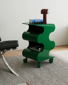 Modern green curved rolling side cart with open shelving and matching green wheels